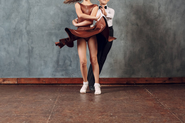Young dancers boy and girl dancing in ballroom dance Samba. Close up legs. - Photo, Image