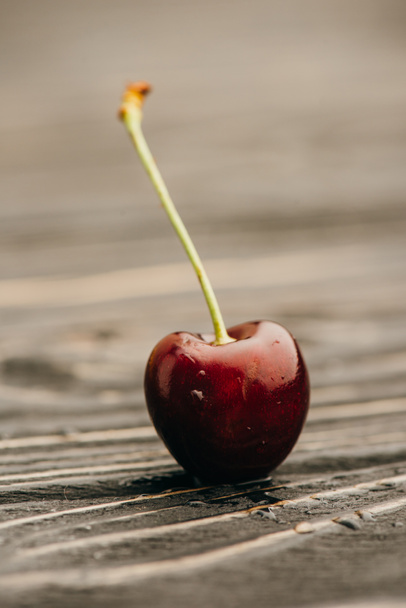 close up view of wet ripe sweet cherry on wooden surface - Photo, Image