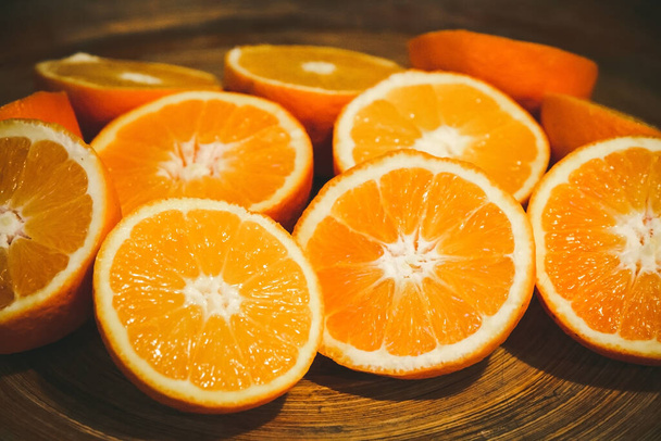 Bunch of fresh organic sliced oranges on a tray - Фото, изображение