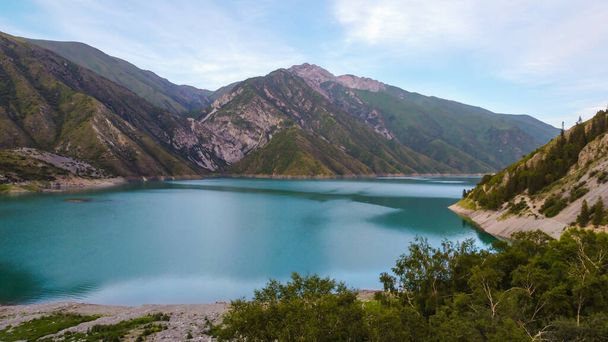 Beautiful mountain turquoise color lake Karasuu in Tian-Shan, Kyrgyzstan. Arial view. Soft focus. Blurred. - Photo, Image