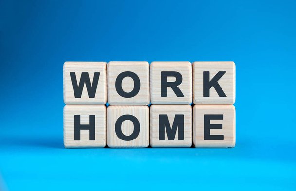 WORK HOME - text on wooden cubes on a blue gradient background - Fotografie, Obrázek