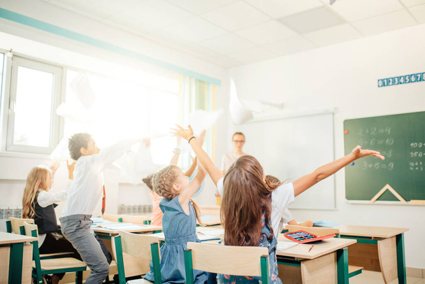school kids have fun in class and throwing paper in air - Фото, зображення