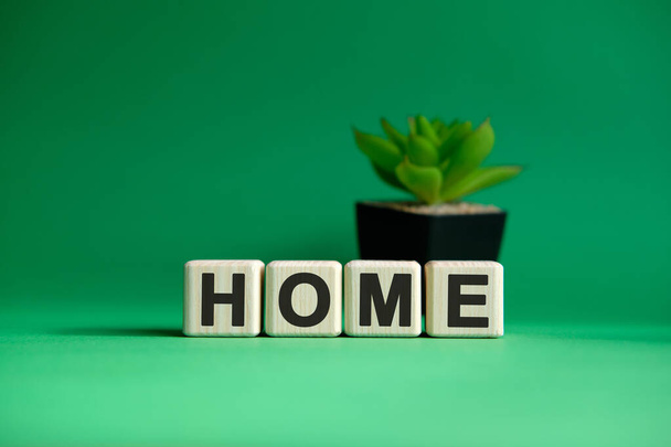 Home website concept text on wooden cubes on a green background - Fotó, kép