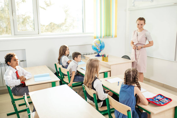 female teacher teaching group of teenagers in high school lesson - Fotografie, Obrázek