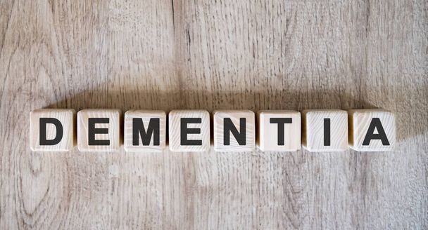 DEMENTIA text word on wooden cubes on wooden background - Valokuva, kuva
