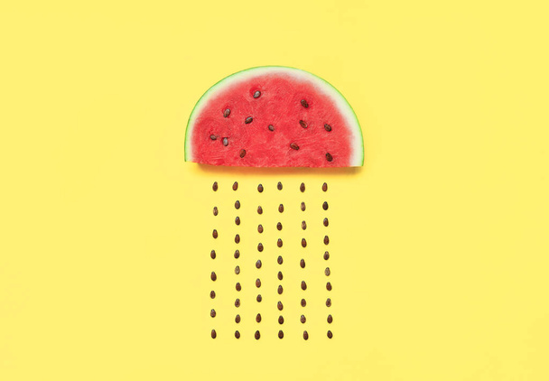 Watermelon slice with seeds on yellow background - Foto, imagen