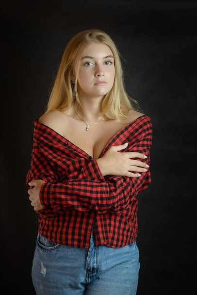 Portrait of beautiful woman with blue eyes in black-red shirt. - Valokuva, kuva