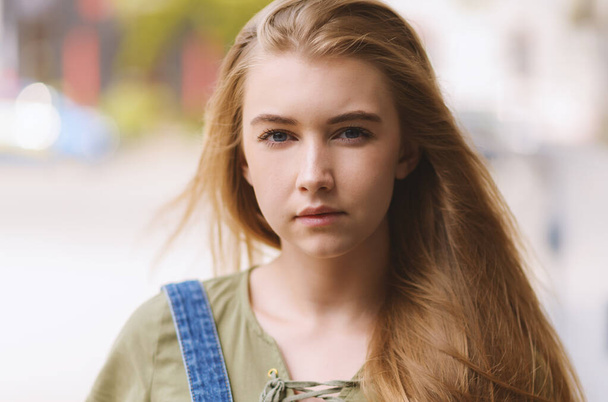 Outdoors portrait of beautiful young woman with blue eyes. - 写真・画像