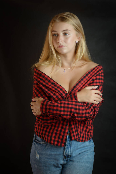 Portrait of beautiful woman with blue eyes in black-red shirt. - Foto, Imagem