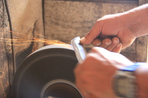 Sparks grinding wheel while knife sharpening - Photo, Image