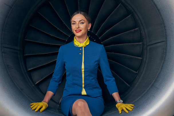 Smiling flight attendant posing for the camera - Photo, Image