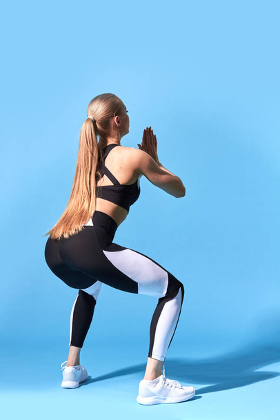 young slim woman doing squat - 写真・画像