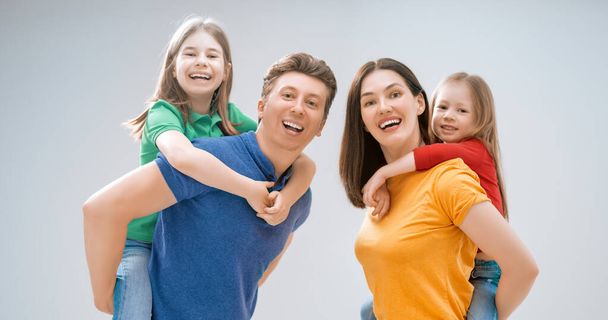 Happy loving family. Mother, father and children daughters on white background.  - Fotoğraf, Görsel