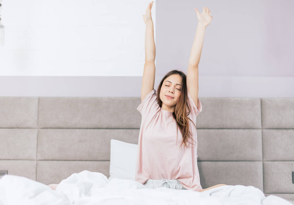 cheerful girl with raised arms waking up - Photo, Image