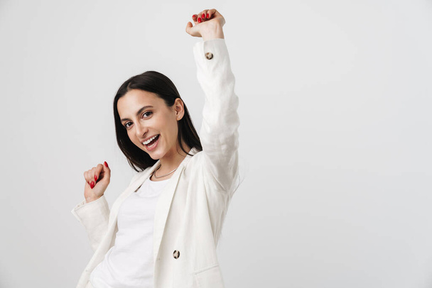 Photo of young joyful businesswoman laughing and dancing isolated over white background - Foto, Imagem