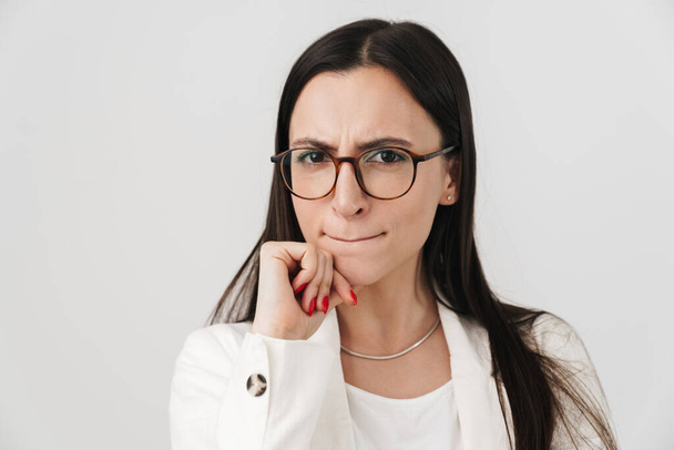 Photo of displeased businesswoman in eyeglasses looking at camera isolated over white background - Fotografie, Obrázek