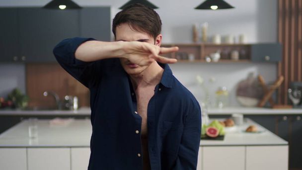 Συναισθηματικός άντρας χορεύει στο φόντο της κουζίνας. Σέξι τύπος που διασκεδάζει σε εσωτερικούς χώρους - Φωτογραφία, εικόνα