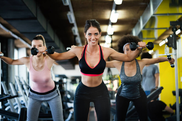 Group of athletic people working out in gym - Photo, Image