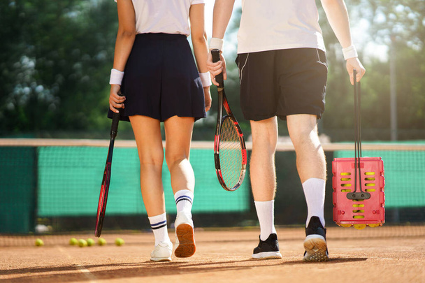 Couple go on the tennis court back view - 写真・画像
