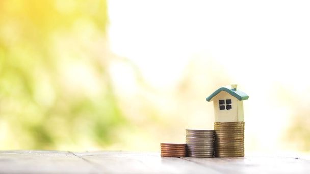 домовая модель по сбережению монет на концепцию инвестиционного ипотечного фонда финансирования и процентной ставки ипотечного кредита - Фото, изображение