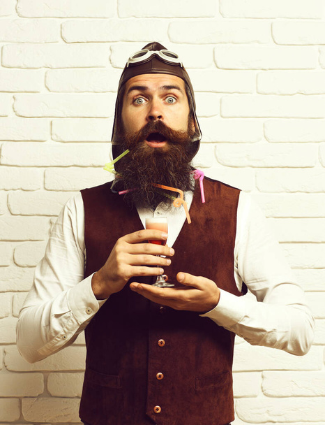 surprised handsome bearded pilot on white brick wall background - Photo, Image