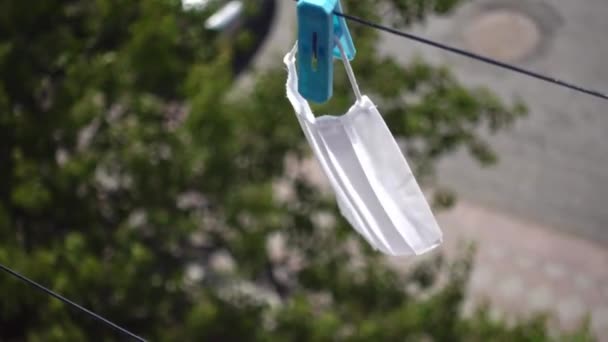Washed surgical masks hanged up with pegs on the rope to dry - Filmati, video