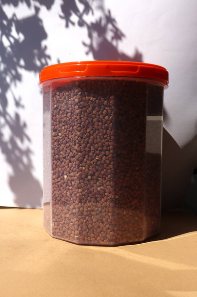 Jar with buckwheat on the table - Photo, Image