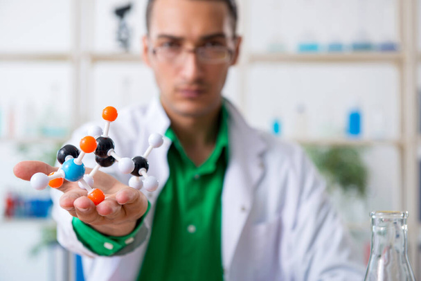 Young male chemist teacher in the lab - Фото, зображення