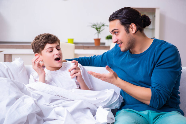 Young father caring for sick son - Foto, Bild