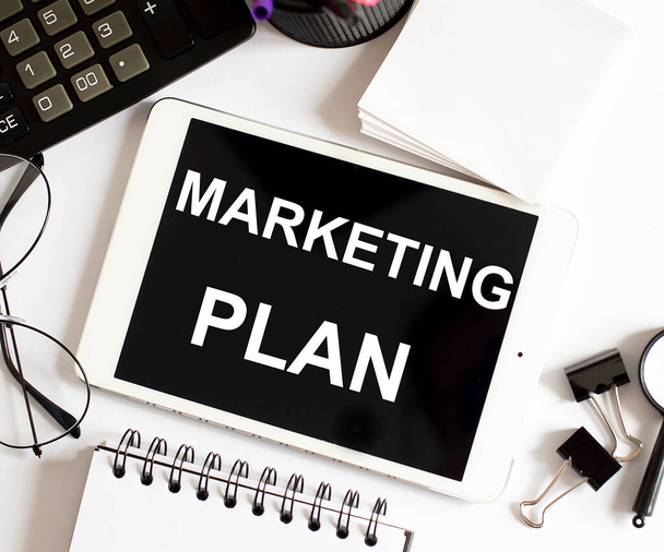 MARKETING PLAN Business Concept on white background with office tools - Foto, Imagen