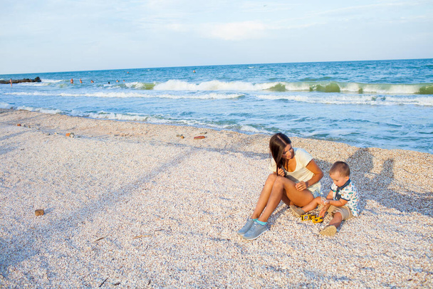Happy mother with 2 years old son at vacation by the sea - Photo, Image