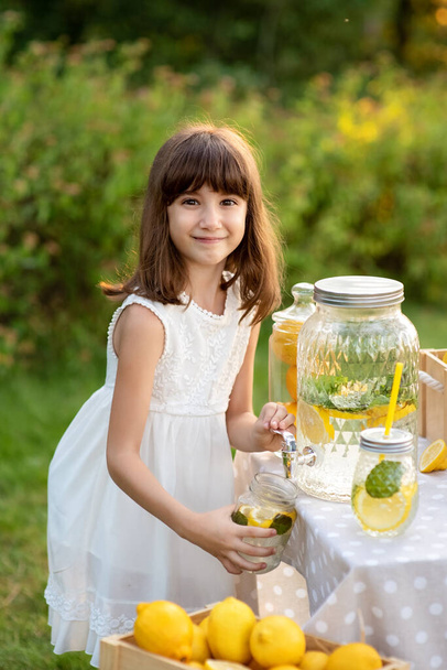 Girl sells homemade lemonade close-up and copy space. - Photo, Image