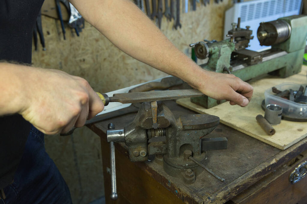Working with a vise and drill. Master's hands at work. Home workshop. - Photo, Image