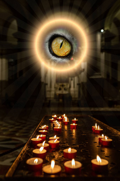 The concept of occultism astrology magic. A magical circle shines above with an eye inside from which rays of light emanate. Candles are burning in a dark church. - Photo, Image