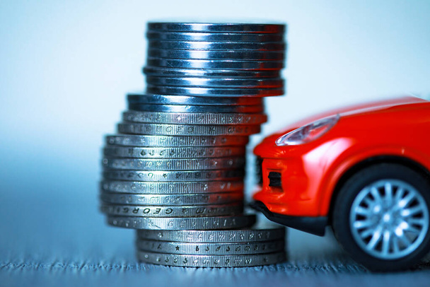coins with red car on des - 写真・画像