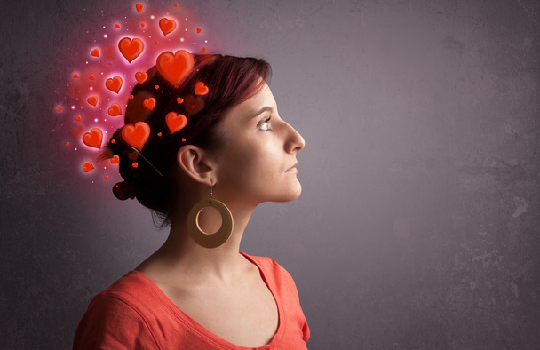 Young person thinking about love with red hearts - Foto, afbeelding
