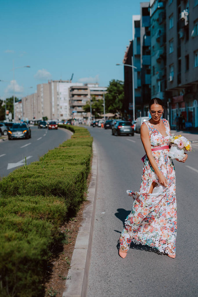 Young beautiful stylish woman in summer dress in city - Photo, image