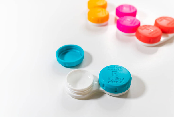 Illustrate different color contact lens cases with lid written replace monthly it is dirty after 30 - Photo, Image