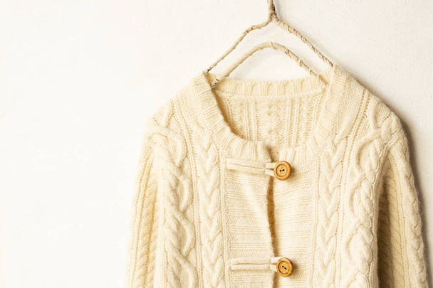 Beautiful, luxurious, a whole knitted cardigan in light beige on white background. - Фото, изображение