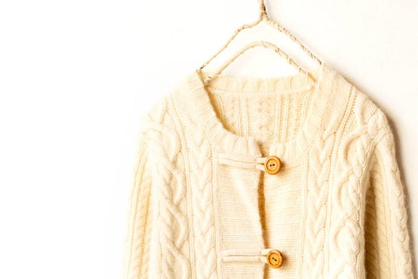 Beautiful, luxurious, a whole knitted cardigan in light beige on white background. - Foto, imagen