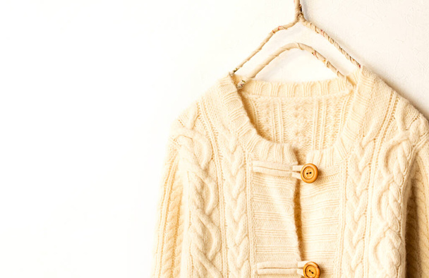 Beautiful, luxurious, a whole knitted cardigan in light beige on white background. - Photo, image