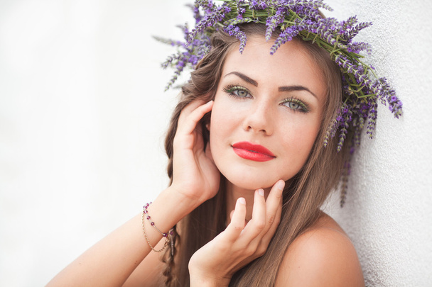 Portrait of young woman in lavender wreath. Fashion, Beauty. - 写真・画像