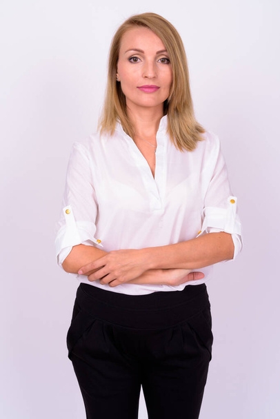 Studio shot of beautiful businesswoman with blond hair against white background - Foto, Imagen