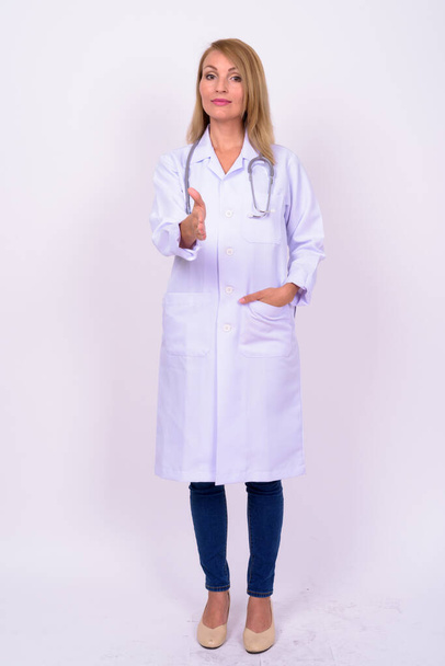 Studio shot of beautiful woman doctor with blond hair against white background - Photo, image