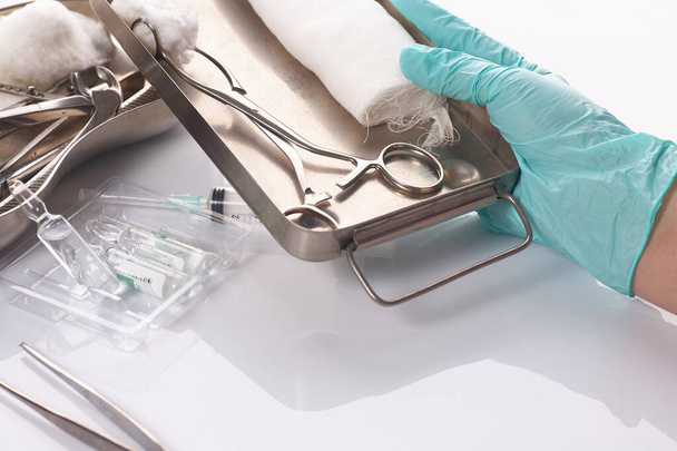Dental appliances in sterile packaging. Dentists hand in gloves - Fotoğraf, Görsel