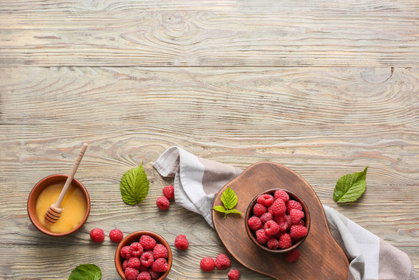 Tasty ripe raspberries with honey on table - Photo, Image