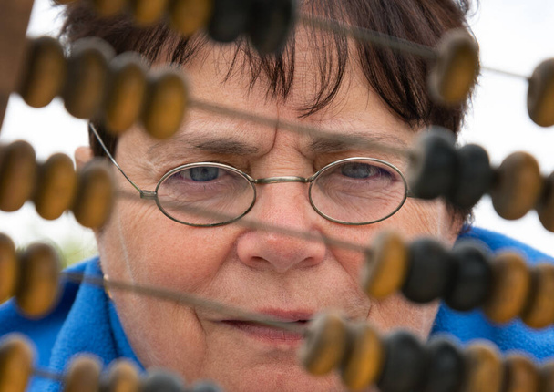 Bookkeeper works with wooden abacus. - Photo, Image