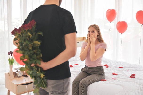 Couple giving rose flower in bedroom happiness in valentine's day selective focus - Фото, зображення