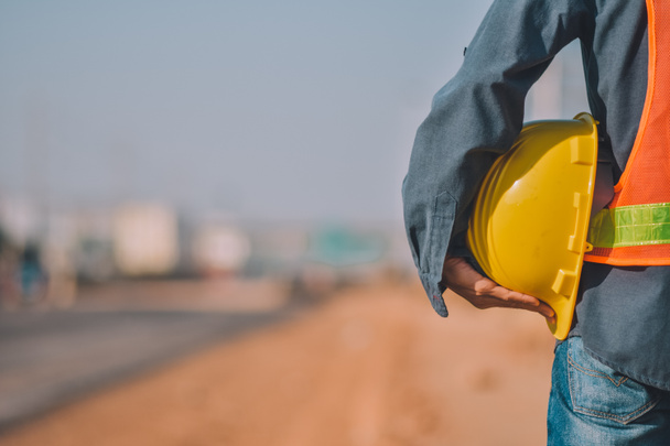 Close up Mérnöki gazdaság Sárga sisak kemény kalap biztonsági és Road építési háttér - Fotó, kép