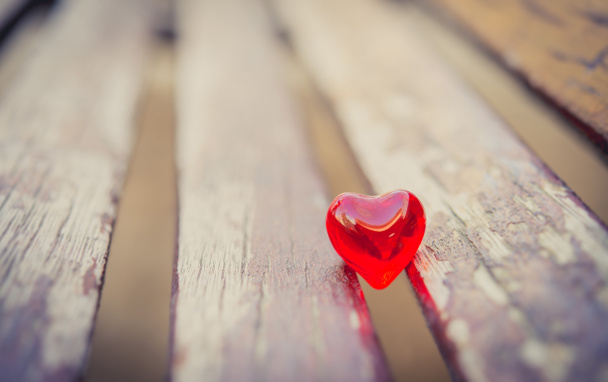 macro red heart on a vintage wooden chair - Photo, Image
